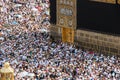 Holy Kaaba in Mecca city. Door of Kaaba - Multazam. Crowd of muslim pilgrims circumambulate - tawaf. Mecca - Saudi