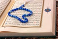 The Holy Koran page with blue rosary Royalty Free Stock Photo