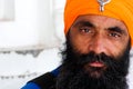 Sikh man wearing orange turban in the golden temple Amritsar Punjab India Royalty Free Stock Photo