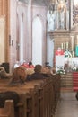 Holy mass with priest and a few elderly people in catholic cathedral church in Poland