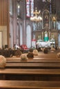 Holy mass with priest and a few elderly people in catholic cathedral church in Poland