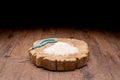 Holy Quran and a grain of rice in a wooden bowl in the sack on a wooden table, Islamic zakat concep