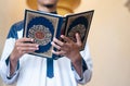 Holy Quran in Hand. Muslim man holding Quran