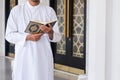 Holy Quran in Hand. Muslim man holding Quran