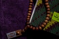 A Holy Quran and Prayer beads on the purple Prayer rug. Eid mubarak or islamic concept