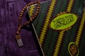 A Holy Quran and Prayer beads on the purple Prayer rug. Eid mubarak or islamic concept