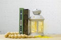 Holy Quran, rosary and lantern on wooden table, with white bric Royalty Free Stock Photo