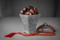 Sacred sweet dates and Islamic praying beads. Royalty Free Stock Photo