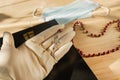 The holy rosary, the Bible and a medical mask lie on the table. Attributes of a Christian during the Coronavirus Period Royalty Free Stock Photo