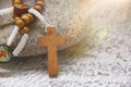 Holy Rosary on top of stone with bright light shining. Spiritual and Christianity concept Royalty Free Stock Photo