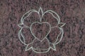 Holy rose and sacred heart on stone surface. Symbol of the holy spirit.