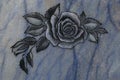 Holy rose symbol on blue vein marble plate. A traditional emblem for the heavenly rose.