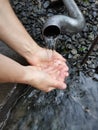 Holy spring. Drink holy water. Spring water. Hands with water. Eco-friendly water.