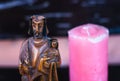 Statue of saint joseph holding the infant jesus, with a candle in the background Royalty Free Stock Photo