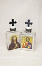 Holy water bottle, Virgin Mother Mary and Jesus Christ icons Royalty Free Stock Photo