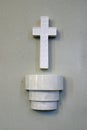 Holy water font and cross in the church of St. Quirinus of Sescia in Sisak, Croatia Royalty Free Stock Photo