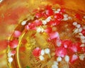 Holy water mixed and flower petals with perfume in a golden bowl by monk in Buddhist merit of Thai