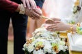 Holy water pouring ceremony over bride and groom hands, Thai traditional wedding engagement Royalty Free Stock Photo