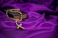 Holy week Bible rosary beads on purple background Royalty Free Stock Photo