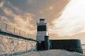 Holyhead Breakwater Lighthouse, on Anglesey in Wales, at the end of a jetty.