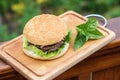 Homamade beef or pork hamburger with vegetable on chopping board with basil leaf in garden, food photoraphy Royalty Free Stock Photo