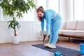 Home activity and training. Fat plump woman exercising and listening to music Royalty Free Stock Photo