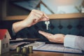 Home agents are handing out keys to home buyers who are signing contracts at the office Royalty Free Stock Photo