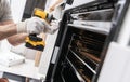 Home Appliances Technician Installing a Stove Royalty Free Stock Photo