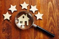 Home appraisal. House with magnifying glass and five star