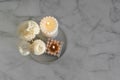 Home aroma fragrance diffuser and burning candles on marble background. Top view