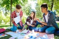 Three stylish students wearing jeans making their home assignment Royalty Free Stock Photo