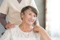 Assistant supporting smiling old lady Royalty Free Stock Photo