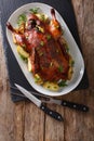 Home-baked duck stuffed with apples close-up on a plate. Vertical top view Royalty Free Stock Photo