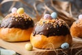 Home baked Easter buns covered with chocolate ganache and decorated with eggs. Traditional holiday pastry