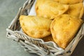 Home Baked Empanadas Turnover Pies with Pisto Vegetable Cheese Filling in Tomato Sauce in Wicker Basket. Spanish Pastry Royalty Free Stock Photo