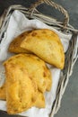 Home Baked Empanadas Turnover Pies with Pisto Vegetable Cheese Filling in Tomato Sauce in Wicker Basket on White Linen Napkin Royalty Free Stock Photo