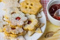 Home baked Gingerbread and Shortbread Cookies Various Shapes Star House Flower with Jam Linzer Powdered. Plate Wood Table