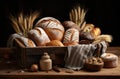 Home-baked loaved of bread in a wooden box, dark table food setting