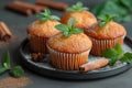 Home-baked muffins with cinnamon and mint on plat