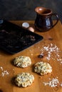 Home baked oats and date cookies on rustic wooden table with egg