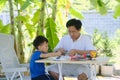 Home Ã¢â¬â based Learning HBL, Parent sitting homeschooling with little kid, Asian Father and son having fun making easy DIY STEM