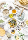 Home beauty products - clay, oatmeal, coconut oil, turmeric, lemon, scrub, dry flowers and herbs, sponges, soap, facial brush on l