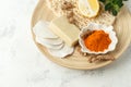 Home beauty products - turmeric, soap, scrub, sponges, lemon, soap, facial brush on light background, top view. Skin youthfulness