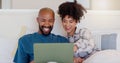 Home, bed and black couple with a laptop, relax and smile with love, internet and streaming a movie. Bedroom, apartment Royalty Free Stock Photo