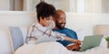 Home, bed or black couple with technology, relax or smile with love, internet or streaming a movie. Bedroom, apartment Royalty Free Stock Photo