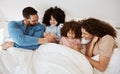 Home bedroom, happy children and parents relax, laugh and bond with kids, rest and enjoy quality time together. Bed Royalty Free Stock Photo