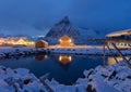 Home, cabin or house at night, Norwegian fishing village in Reine City, Lofoten islands, Nordland county, Norway, Europe. White Royalty Free Stock Photo