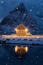 Home, cabin or house at night, Norwegian fishing village in Reine City, Lofoten islands, Nordland county, Norway, Europe. White Royalty Free Stock Photo