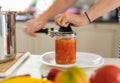 Home canning of vegetables. A woman in close-up preserves a vegetable salad in a glass jar Royalty Free Stock Photo