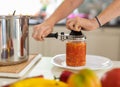 Home canning of vegetables. A woman in close-up preserves a vegetable salad in a glass jar Royalty Free Stock Photo